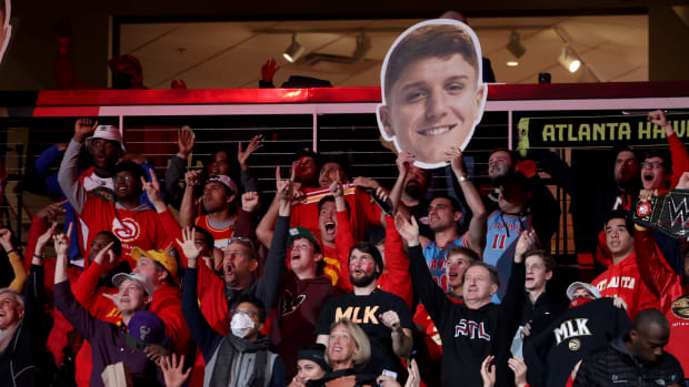 Jan 17, 2022; Atlanta, Georgia, USA; Atlanta Hawks fans cheer as they hold an image of Atlanta Hawks guard Kevin Huerter during the second half against the Milwaukee Bucks at State Farm Arena.